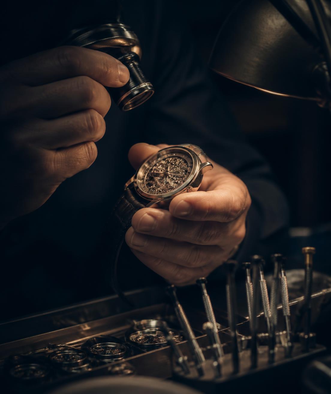 Watch specialist examining a fine timepiece